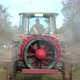 Rear view of a tractor spraying or fertilizing an olive grove with chemicals - VideoHive Item for Sale