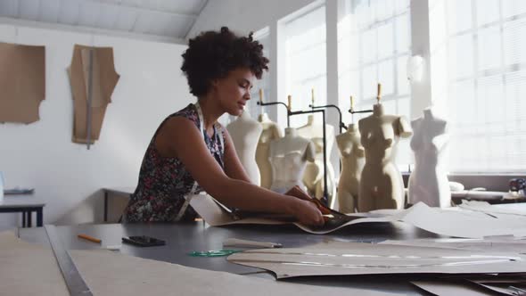 Mixed race woman working in creative office