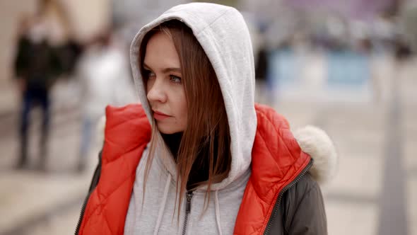 Portrait of a Sad Middleaged Woman Standing on a Busy City Street