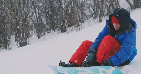 The Man Sitting in the Snow Zipper Boots Snowboard