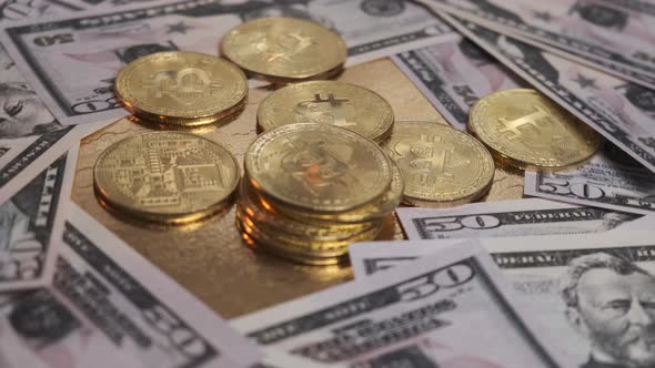 The Bitcoin Coin Rotates on a Table Strewn with Dollars