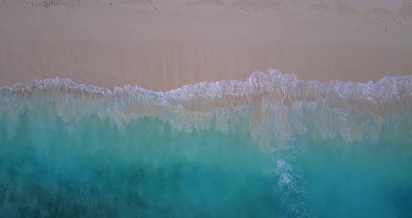Luxury birds eye clean view of a paradise sunny white sand beach and aqua blue water background in 4