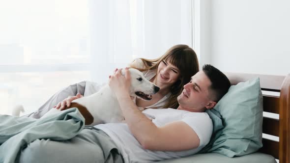 Couple with Dog in the Bed