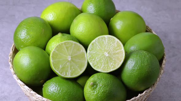 Basket with whole and halved fresh limes