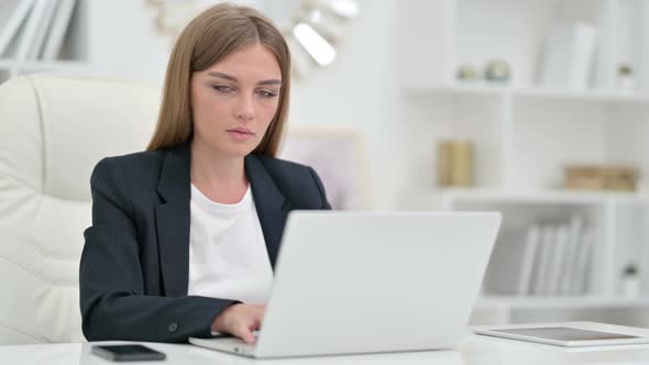 Thumbs Up By Positive Young Businesswoman at Work