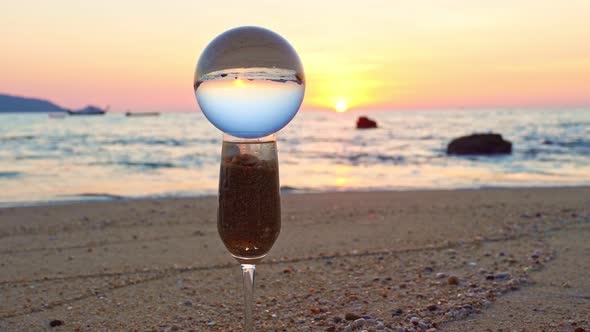 The Glass Of Water Was Filled With Sand And Crystal Ball