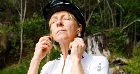 Senior cyclist wearing bicycle helmet at countryside 4k