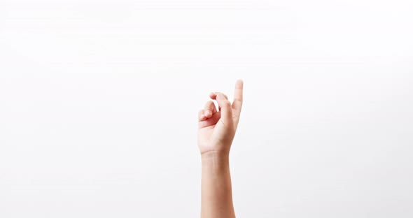 Close up of a woman making gestures with one arm with touching on a white studio background with cop