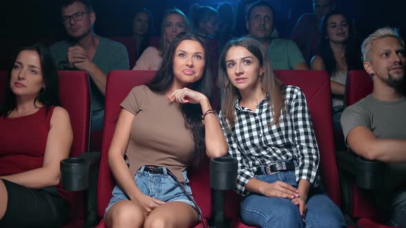 Happy Female Girlfriends Gossiper Whispering Secret Discussing Action Scene Watching Movie at Cinema