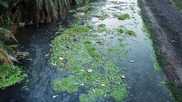 Rubbish flow on dark river. Ecological problem. Environment pollution.