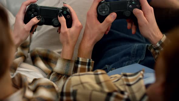 Players Hands Holding Gamepads Resting Home Closeup