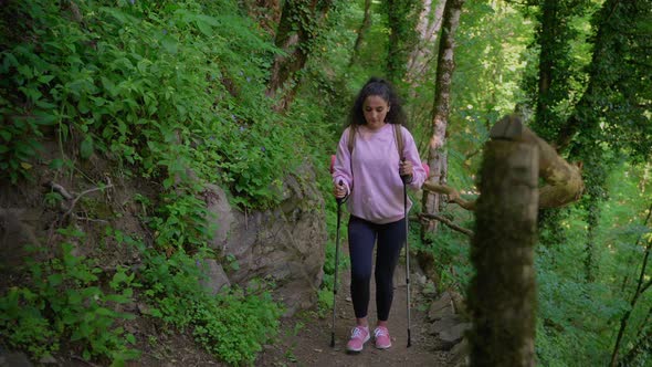 Hiker Climbing Up the Path in Mountain Forest