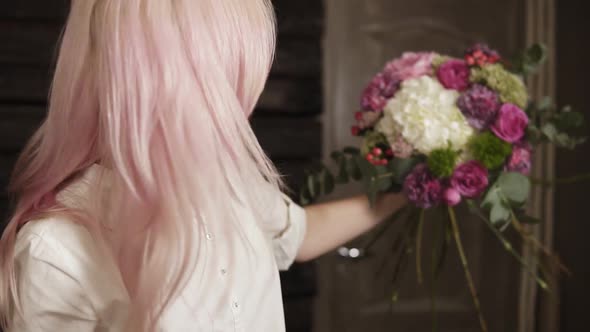 The Girl Florist is Concentrated on a Bouquet Arranging