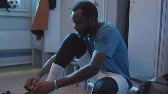 Man Tying up Cleats