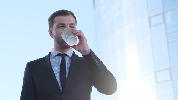 Handsome Businessman Drink Coffee Outdoor in Morning on Street