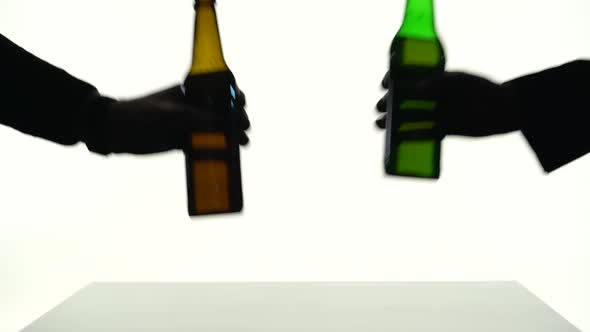 Two Beer Bottles Put on the Table at the Same Time. Silhouette White Background