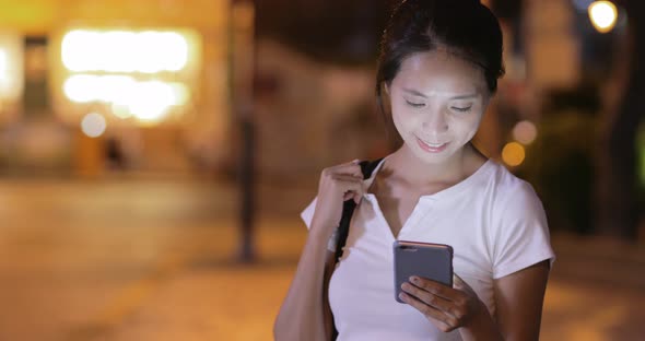 Woman watching on mobile phone at outdoor 