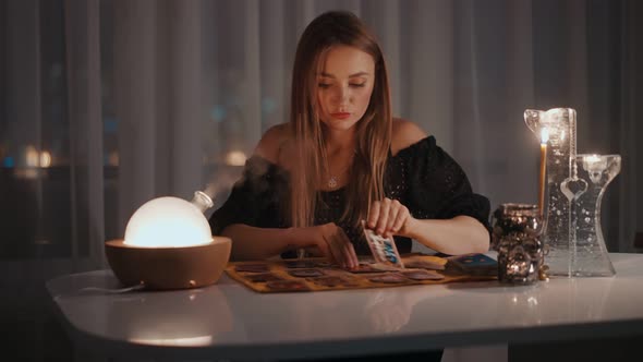 Woman Reading Tarot Cards in Spiritual Room