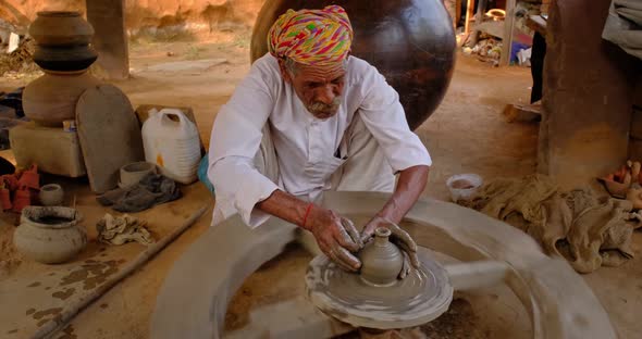 Indian Potter at Work: Throwing the Potter's Wheel and Shaping Ceramic Vessel and Clay Ware: Pot