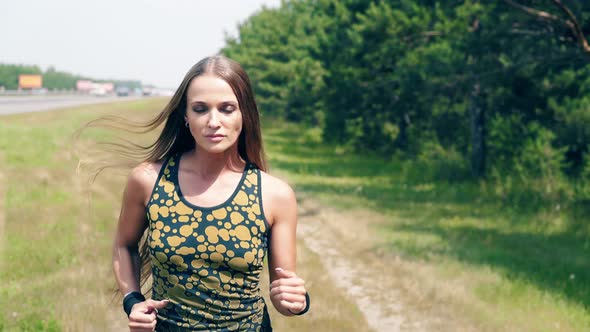 CU, Portrait: Young Girl Goes in for Sports in the Morning, Runs Along Pine Forest and Trails. Wraps