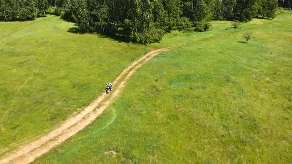 Motorcyclist Rides out Of the Woods