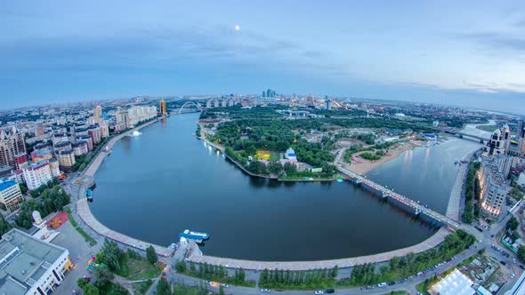 Elevated View Over the City Center with River and Park and Central Business District Day To Night