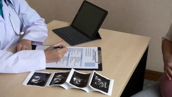 Pregnant Woman and Gynecologist Doctor at Hospital