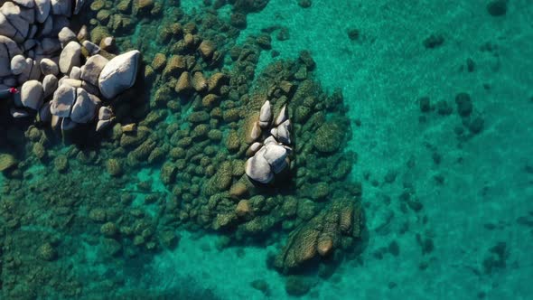 Rocks On Seabed Seen Through Crystal-clear Water At Summer. - aerial ascend, spin