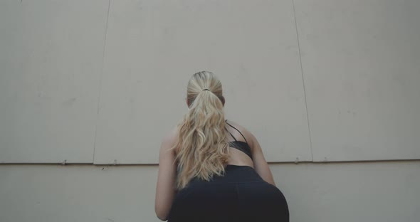 Young Woman Squatting To Throw And Catch Medicine Ball