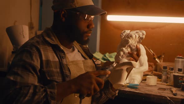 Black Sculptor Polishing Part of Bust