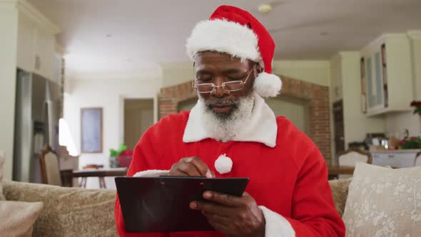 Senior african american man wearing santa costume at christmas time