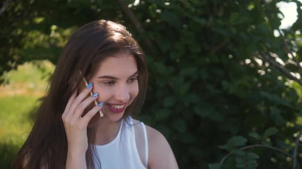 Technology, Education and People Concept - Smiling Young Woman or Teenage Girl Call Talk Smartphone