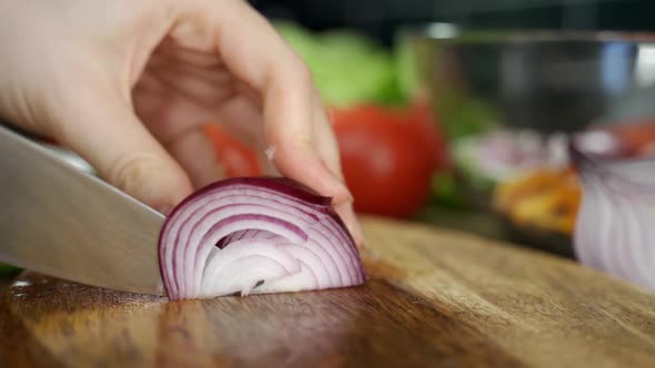 Chef Using a Knife Cutting Fresh Raw Onions