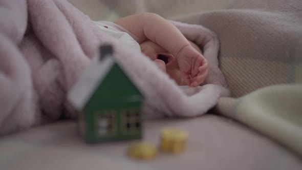 Portrait of Yawning Newborn Infant Girl Stretching Hands in Slow Motion Lying in Bed Falling Asleep