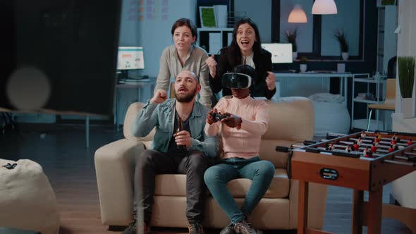 Multi Ethnic People Cheering While Woman Winning Game