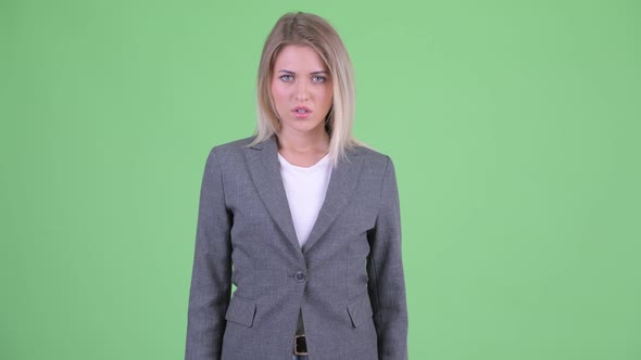 Angry Young Blonde Businesswoman Giving Thumbs Down