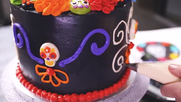 Step by step. Baker decorating multilayer chocolate cake with colorful italian buttercream frosting.