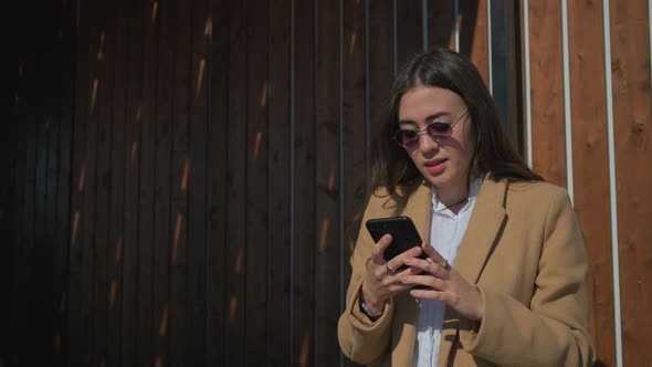 Girl Texting on Smartphone Outdoor