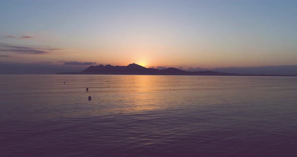 Sunset over island in sea