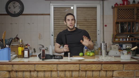 Young Caucasian Male Playing with a Lime Before Slicing It with a Sharp Knife