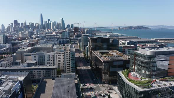 Aerial shot flying over Mission Bay and 3rd Street towards downtown San Francisco. 4K