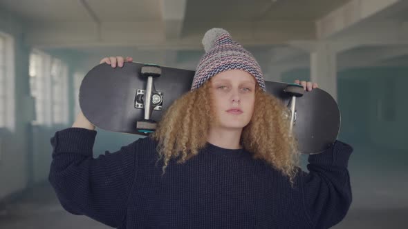 Fashionable young woman in an abandoned warehouse