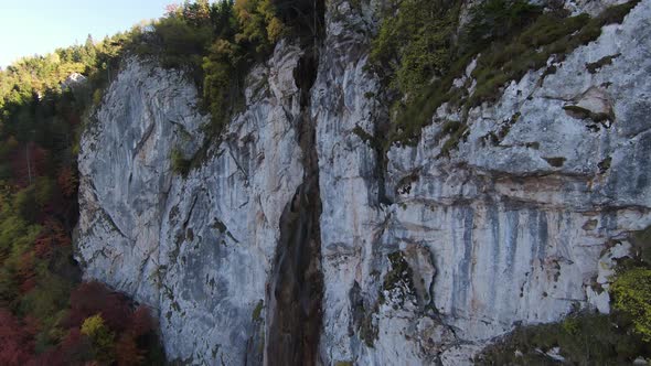 Aerial View of Autumn Waterfall Flying Over Forest in the Autumn Big Stones in the River Waterfall