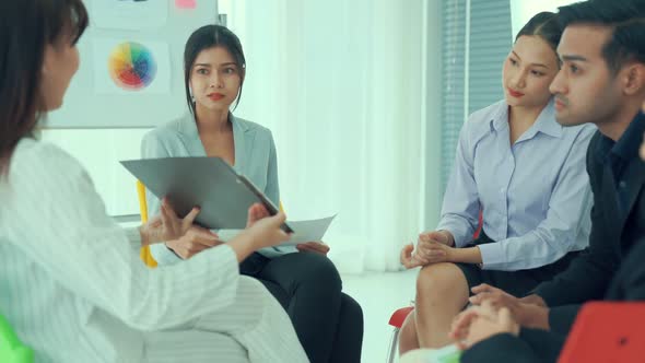 Business People Proficiently Discuss Work Project While Sitting in Circle