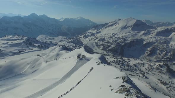 Aerial Mountain Ridge With Snow and Ski Lift