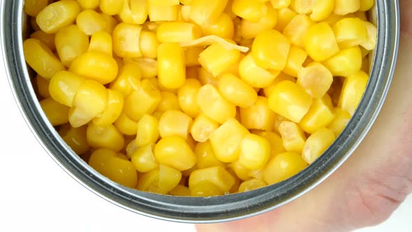 Hand Opens Metallic Tin Can of Marinated Sweet Corn