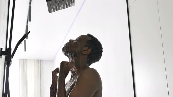 AfricanAmerican Man Takes Hot Shower in Light Bathroom