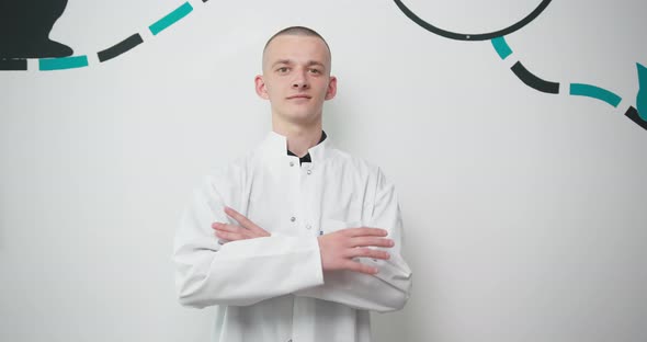 Young Man Doctor Veterinarian with Arms Crossed Looking at Camera