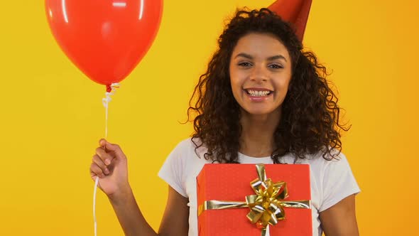 Excited Girl With Gifts Posing for Camera, Discounts and Promotions for Birthday