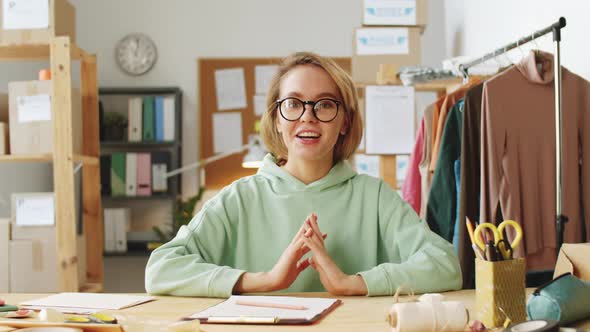 Cheerful Female Owner of Clothes Shop Speaking at Camera